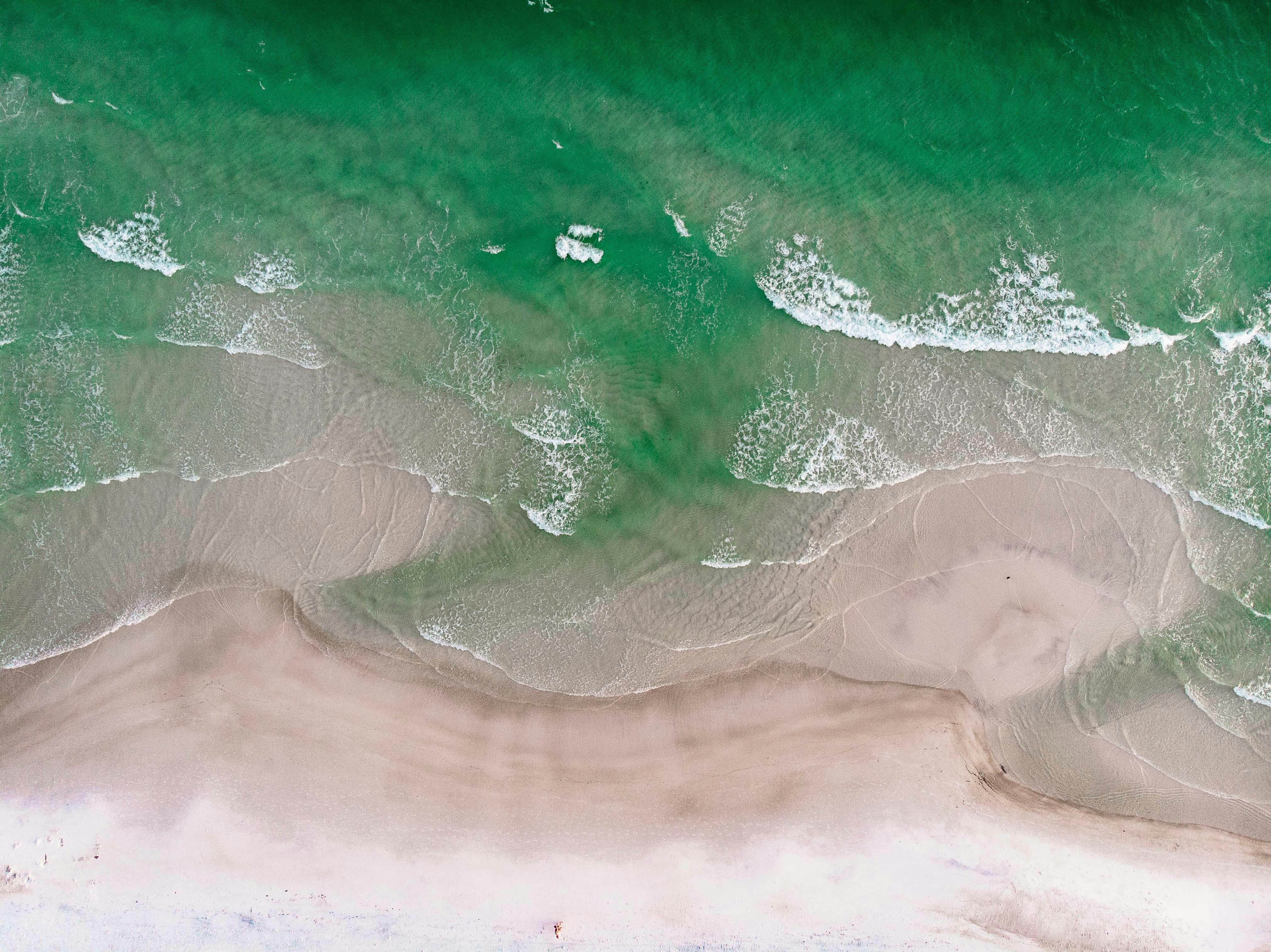 bird's-eye photography of shore beside body of water by John Price courtesy of Unsplash.